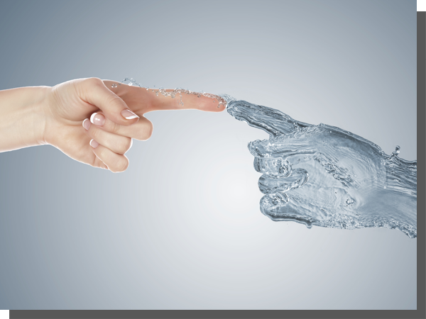 A human hand reaching out to touch fingertips with a hand formed of water