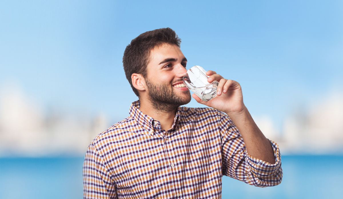 Man drinking a glass of clean water